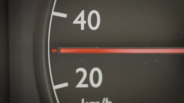 Detailed view of an analog speedometer dial measuring speed at 30 kmh mph, representing urban driving and traffic zones