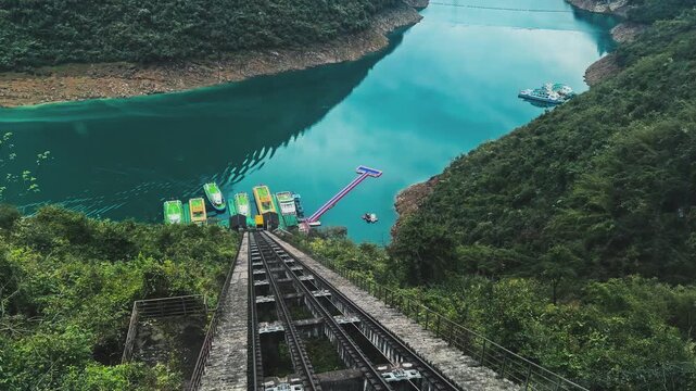 Funicular Railways Descend The Steep Valley Cliffs To The Riverbank Pier Of Furong River Scenic Area In Chongqing, China. POV Shot