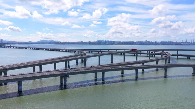 Coastal highway bridge spanning Jiaozhou Bay, Qingdao urban transportation landscape under cloudy sky