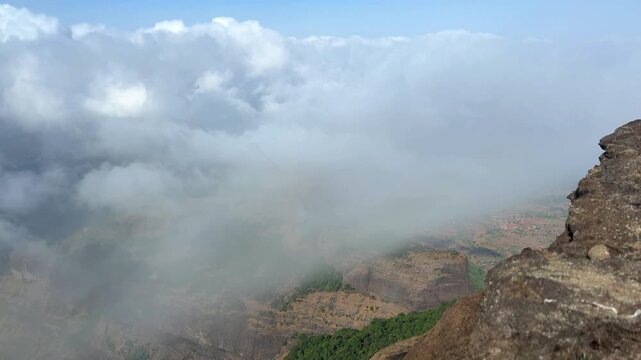 Thick cloud formation and movement seen from the top of Harishchandragad near Malshej, Maharashtra.