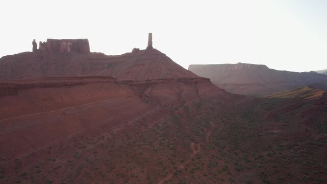 Drone flying sideways at Castleton Tower in moab at sunrise in 4k