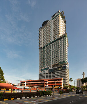 Kuala Lumpur, Malaysia - March 01, 2025: The Face Suites skyscraper towering above SMK Puteri Wilayah school on a sunny day in the city center of Kuala Lumpur