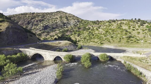 Cinematic View of Historic Kasrik Bridge in Siirt, Turkiye &ndash; Stone Arch Bridge Over Botan River and Anatolian Heritage