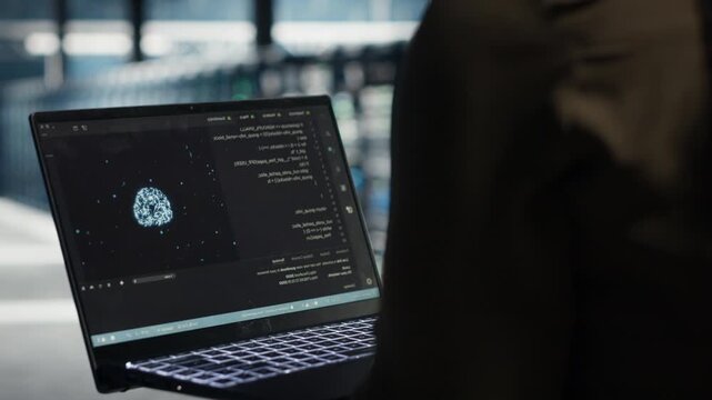 Admin uses green screen laptop in a data center for equipment checkups, infrastructure maintenance, network monitoring and steady IT infrastructure control within a practical data center workflow.