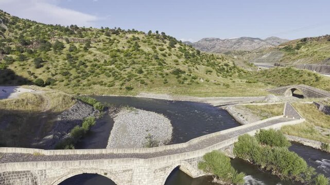 Cinematic View of Historic Kasrik Bridge in Siirt, Turkiye &ndash; Stone Arch Bridge Over Botan River and Anatolian Heritage