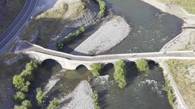 Cinematic View of Historic Kasrik Bridge in Siirt, Turkiye &ndash; Stone Arch Bridge Over Botan River and Anatolian Heritage