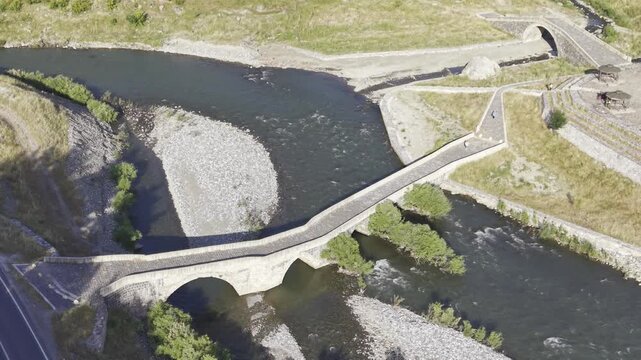 Cinematic View of Historic Kasrik Bridge in Siirt, Turkiye &ndash; Stone Arch Bridge Over Botan River and Anatolian Heritage