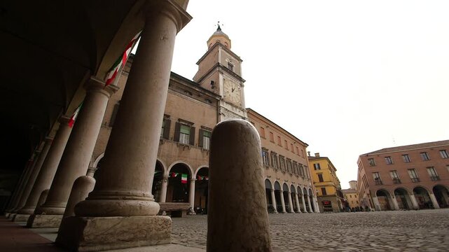 Cinematic slider shot revealing Piazza Grande with its historic civic architecture and arcades in Modena, Italy. Ideal for travel, culture and tourism projects.