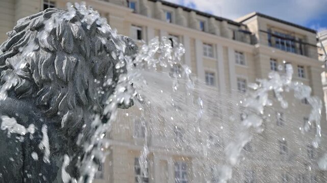 Lion head statue spitting water from a fountain in Skopje