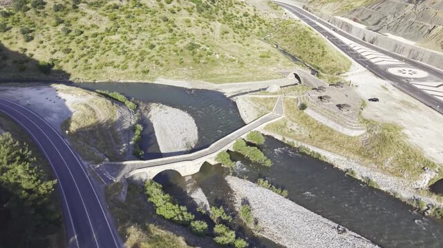 Cinematic View of Historic Kasrik Bridge in Siirt, Turkiye &ndash; Stone Arch Bridge Over Botan River and Anatolian Heritage