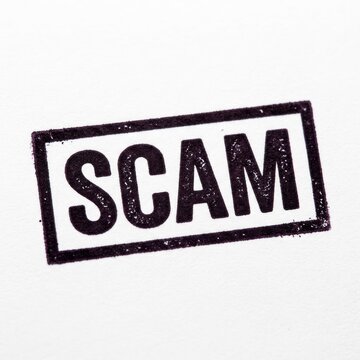 Stamp with the word Scam in black ink on a white background.