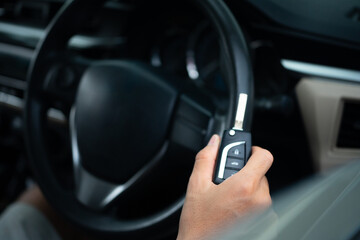 Obraz premium Close Up of Man Holding car key ready to drive.
