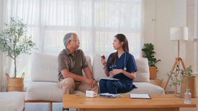 Female caregiver provides medication guidance and explains how to take medicine to an elderly man during a nursing at home visit, senior care, elderly care, and home healthcare support.