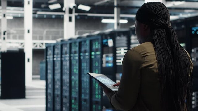 Woman engages with online video content near a digital wall, suggesting streaming videos and social media videos.