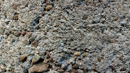 Concrete Texture Background with Rough Gray Cement and Embedded Pebbles for Industrial Design © NOVRIN