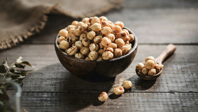 Roasted makhana fox nuts in a wooden bowl on a rustic kitchen table