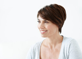 Fototapeta premium Woman, thinking and daydream with smile in studio, space and remember good memories or contemplating. Past, thoughts and reflection with nostalgia, white background and happy person with decision
