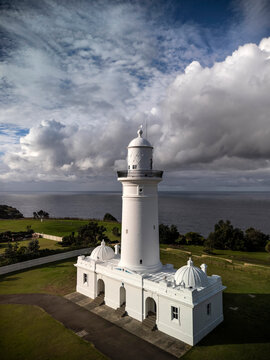 MacQuarie lighthouse vertical in Sydney, Australia from aerial view with ocean and dramatic stormy sky in the background