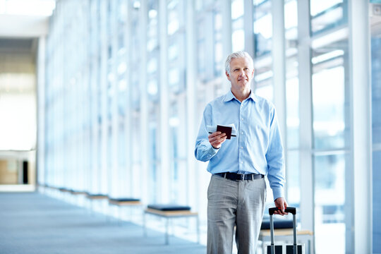 Airport, space and mature man for business, work trip and suitcase for convention in terminal. Happy, professional and person with ticket, boarding pass and walking for commute, travel and conference