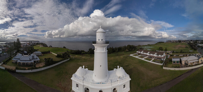 MacQuarie lighthouse panorama in Sydney, Australia from aerial view with ocean and dramatic stormy sky in the background