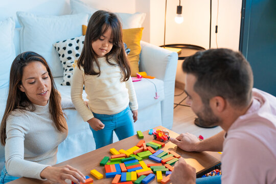 Happy family playing together in the living room