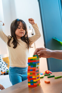 Girl happy to win the jenga game to remove blocks