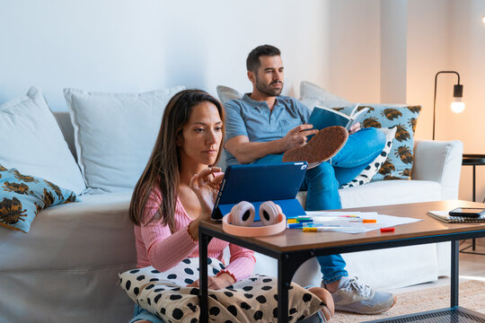 Couple working and reading in the living room