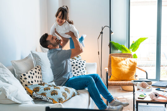 Father lifting his daughter in the air