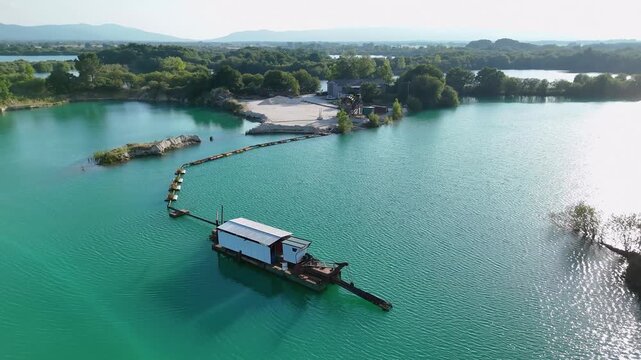 Dredging boat extracting sand and gravel from lake bed