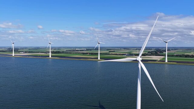 Aerial view of wind turbines and solar panels along the IJsselmeer in the Netherlands