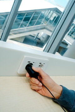 a man connects a charger in a public space
