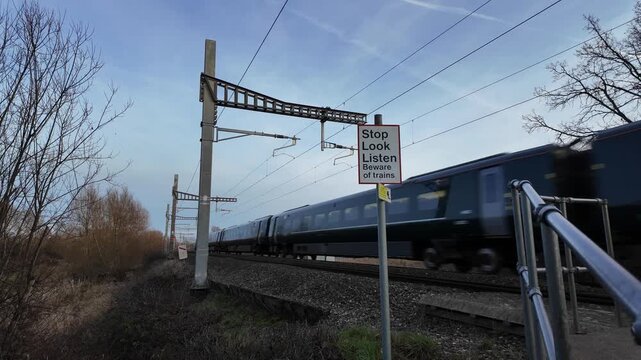 Train goes through a train track crossing at high speed