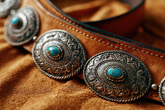 Leather belt with ornate silver conchos and turquoise stones