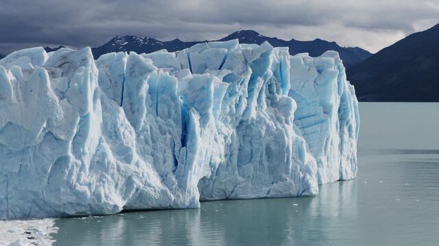 Perito Moreno Glacier towers above Lago Argentino in Los Glaciares National Park, Santa Cruz, Argentina, illustrating glacial geology, freshwater resources and climate change impacts, drone telephoto