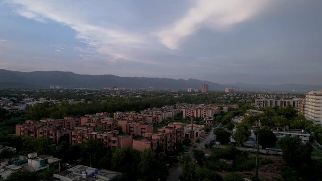 Evening light settles over residential districts with Margalla Hills stretching across the horizon, Islamabad, Pakistan