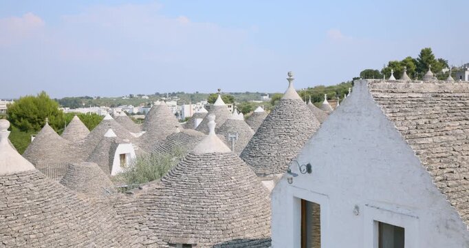 Close-up view of conical stone roof and white wall of traditional trullo house in Alberobello, Italy. Tilt-up, copy space