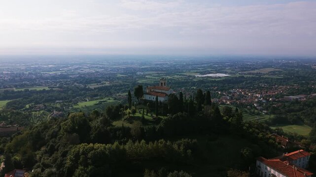 Beata Vergine del Carmelo Sanctuary on hilltop in Montevecchia, Italy. Aerial backward, copy space