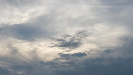 Obraz premium Dramatic Storm Clouds with Sunlight Breaking Through Moody Evening Sky View