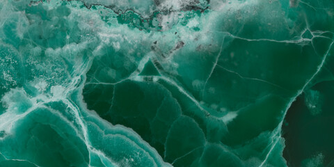 Elegant emerald green onyx marble texture with translucent layers and natural stone veins. © Vidal