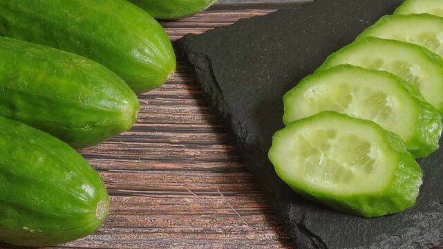 sliced ​​cucumbers on a black slate plate