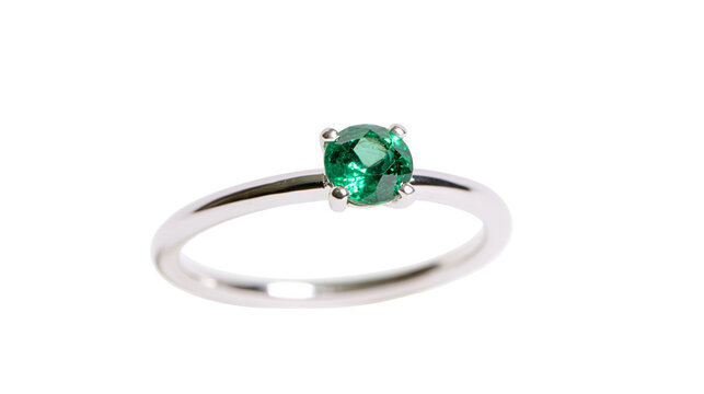 Delicate silver ring with a single round green emerald gemstone, isolated on transparent background