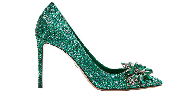 Sparkling green glitter stiletto heel shoe with emerald jewel embellishment, isolated on transparent background