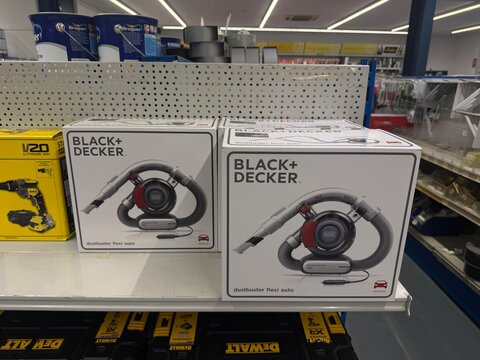 Mallorca, spain, june 27, 2026, black plus decker dustbuster flexi auto car vacuums display on retail shelf in hardware store with dewalt tools