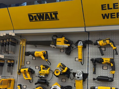 Mallorca, spain, june 27, 2026, dewalt power tools displayed on a perforated wall in a hardware store, showing a range of yellow electric equipment