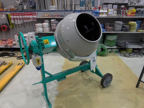 Mallorca, spain, june 27, 2026, concrete mixer on display inside a hardware store, representing construction, renovation, and home improvement supply needs