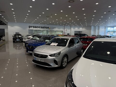 Mallorca, spain, june 27, 2026, modern car dealership showroom displaying a variety of new and used vehicles for sale, including a silver opel corsa
