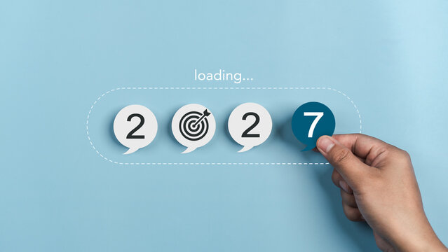 Goals 2027 concept, and goal setting for the new year. growth, readiness, and the journey toward achieving success and chance. progress loading bar and goal icon. Hand holding paper number seven.