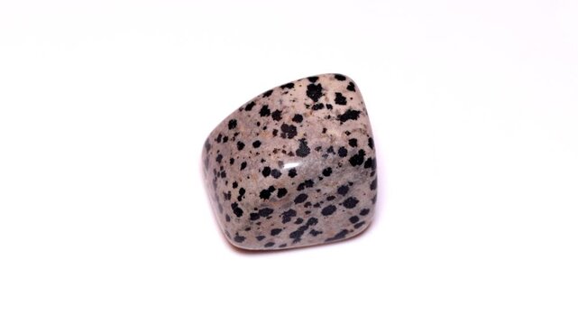 Aplite arfvedsonite dalmatian tumbled stone isolated white background