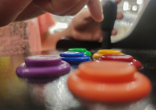Child boy gamer pressing 6-button arcade controller