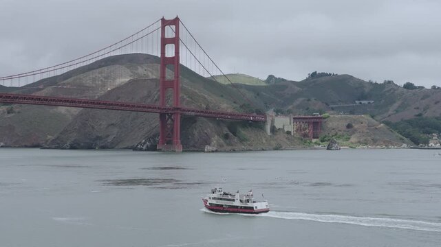 Passenger Ferry Preparing To Pass Under Golden Gate Bridge - Aerial Shot With Overcast Sky